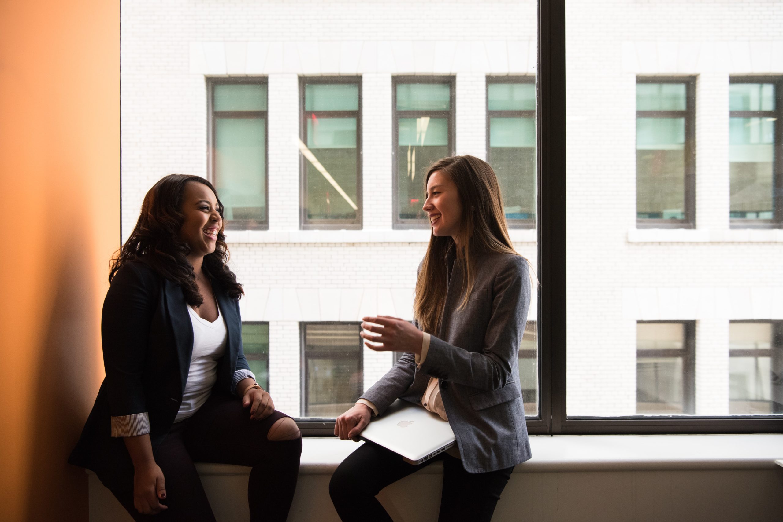 Two women chatting at work